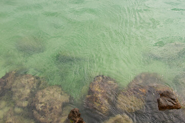 Sea view from above coastline with underwater rocks in Syracuse, Sicily, Italy.