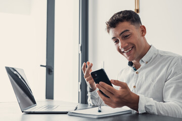 Man sit at desk read e-mail on laptop makes yes gesture feels happy. Male entrepreneur get great...