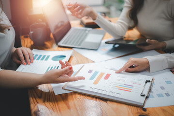 Group of business people analysis summary graph reports of business operating expenses and work data about the company's financial statements..