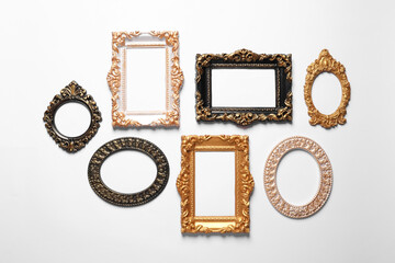 Blank vintage frames hanging on white wall