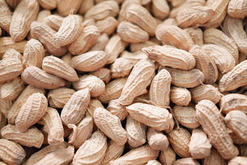 Peanuts in the shell on the wooden background. Close up.