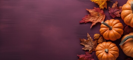 top view fall halloween still life with pumpkin and leaves with copy space, Vibrant autumn pumpkins and leaves on a purple background. Fall harvest design template