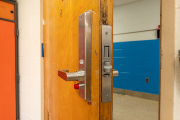 Open classroom door with new door hardware with security locks for a lockdown.