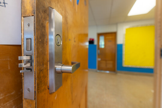 Open classroom door with new door hardware with security locks for a lockdown.