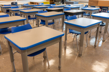 Example of an empty nondescript US High School Classroom with desks.	
