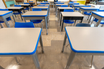 Example of an empty nondescript US High School Classroom with desks.	