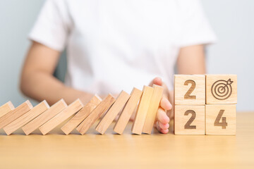 2024 year with falling blocks on table, Risk Management, recession, business financial, Resolution,...