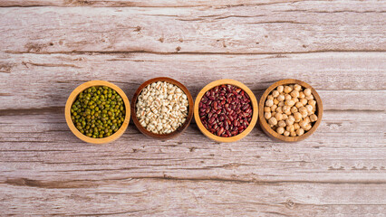 Mung beans, Red kidney beans, Chickpeas source and peeled barley in a basket wooden isolated on wood background
