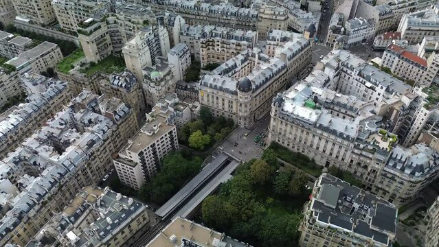 Paris centre buildings with railway crossing city. Aerial tilt down view