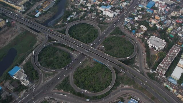Aerial footage of Chennai's Maduravoyal flyover bridge shows moving traffic and nearby buildings.