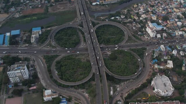 The Maduravoyal flyover bridge in Chennai can be seen from above, along with nearby structures and moving traffic.
