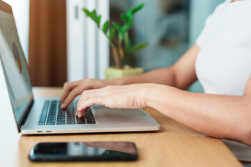 Fototapeta premium Casual Businesswoman using laptop, freelance woman typing keyboard computer notebook in cafe or modern office. technology, digital online and network concept