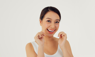 Beautiful women, polite care, women of beautiful and clean teeth using dental floss.