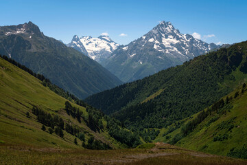 View of the peak of Mount Pshish - the highest peak near the village of Arkhyz on a sunny summer day, North Caucasus, Karachay-Cherkessia, Russia