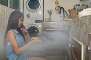 Housewife failed to cook : Young Asian housewife in the kitchen baking bread in the microwave oven...