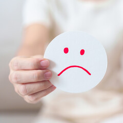 Fototapeta na wymiar Woman show Unhappy Sad face paper, Mental health Assessment, Psychology, Health Wellness, Feedback, Customer Review, Experience, Satisfaction Survey, Negative Thinking and World Mental Health day