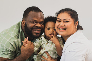 Happy family relationship moments, portrait african american handsome father and beautiful Asian...