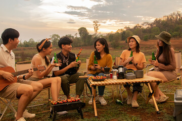 Camping in the evening, sunset behind the mountain with beautiful nature : Young asian gangs of...