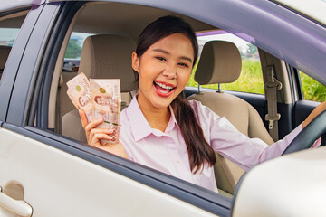 Happy young woman drives safe car with insurance from an insurance company care and compensation...
