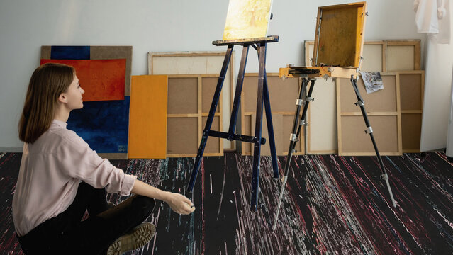 Digital art. Nft investment. Crypto marketplace. Relaxed satisfied woman enjoying viewing abstract artwork in studio interior with glitch noise floor.