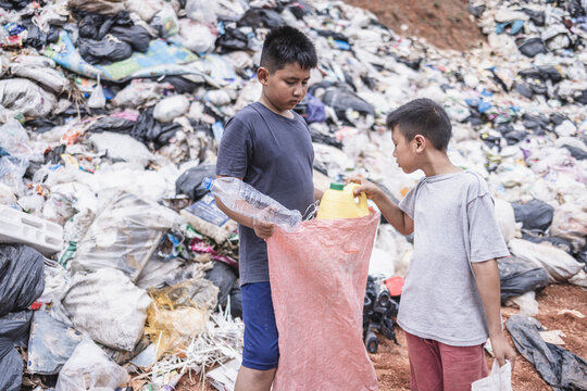Poverty in India, a child collects garbage in a landfill site, Concept of livelihood of poor children.Child labor. Child labor,  human trafficking, Poverty concept.