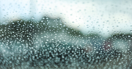 Raindrops on window, a poetic embrace of solitude and renewal. Symbolizes nature's teardrops...