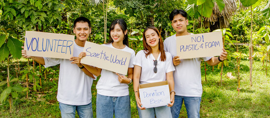 Group asian men and women volunteers hold paper banners campaign environmental protection refrain...