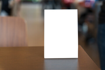 Menu mock up blank for text marketing promotion. Mock up Menu frame standing on wood table in restaurant space for text.