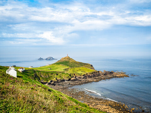 Cape Cornwall, seen from the SW Coast Path, with Porth Ledden in the foreground and The Brisons offshore rocks beyond.