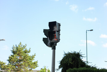 Street lights and walking sign amidst traffic signify city's rhythm, safety, and pedestrian unity