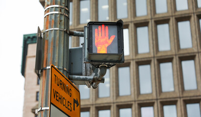 Street lights and walking sign amidst traffic signify city's rhythm, safety, and pedestrian unity