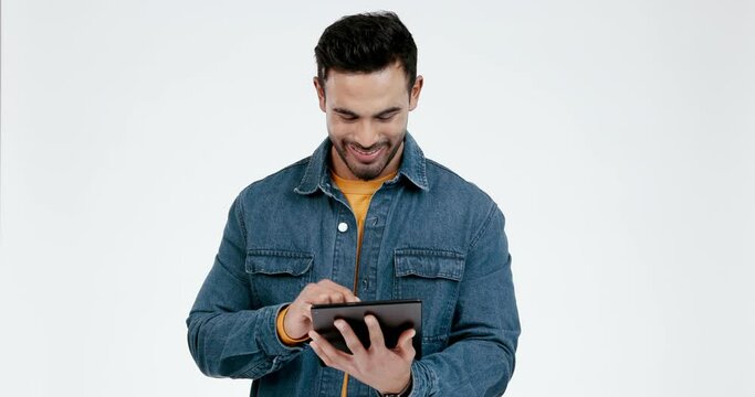 Man, happy and tablet for social media in studio on white background, ebook and search website for movie and meme. Phone, smile and Indian person with digital touch for internet and scroll