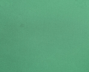 Close-up texture of natural  Green fabric or cloth in light  Green color. Fabric texture of natural cotton or linen textile material. Green canvas background