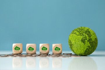 Carbon credit.Reduction of carbon emissions.Wooden cube with co2 icon on coins with the green...
