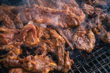 smoky BBQ delight grilling marinated lamb slices on a charcoal stove