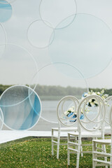 Place for wedding ceremony on river beach outdoors. Large installation of round arch