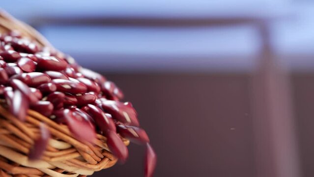 Red beans falling from a basket and a basket of red pomegranate seeds