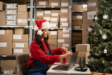 Female online store small business owner seller wrapping gift packing box preparing delivery parcel...