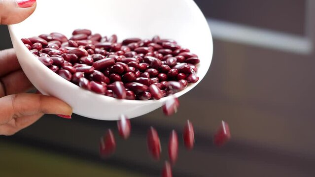 Red beans falling from a white plate; close-up of a light bulb; red beans falling from a white bowl