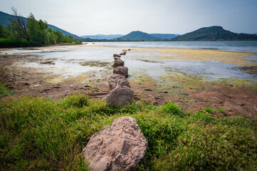 Landscape of red rocks and Green algae in summer of Lake Salagou , Occitanie, France, High quality photo