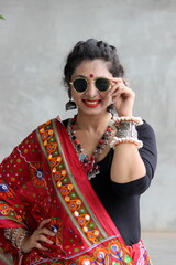 Indian woman in a stylish traditional look for Navratri for playing Garba and dandiya wirh sun...