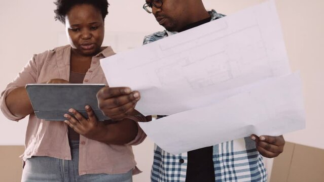 Black Couple Looking at Building Plans