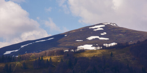 carpathian mountains nature background in spring. landscape with snowcapped hill in morning light...