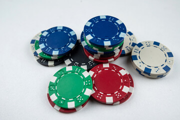 different color poker chips isolated on white gray background