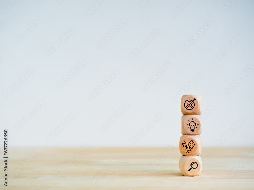 Aufkleber business strategy and action plan icon on four wooden cube blocks stack isolated on wood shelf and w