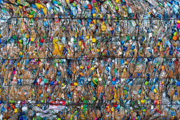 Fototapeta na wymiar Bundle of plastic bottles and plastic wasted products being smashed and tightly tied up for recycle purpose