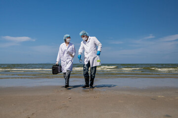Scientist anaylist wearing protective uniform,mask,glove and box under working water analysis...
