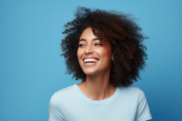 Portrait of a Woman Smiling Looking to the Side Black Woman Blue Background - obrazy, fototapety, plakaty