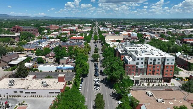 Summer shot of quaint town in Colorado. Aerial glide above pedestrian friendly road. Beautiful establishing shot by drone.