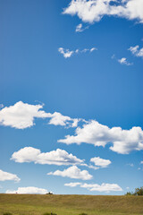 Clouds, blue sky and green grass background